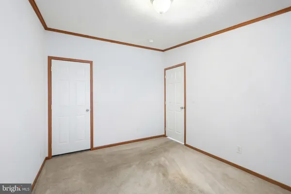 a view of a hallway with white walls