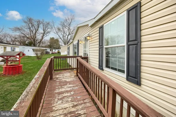a view of a house with backyard and deck