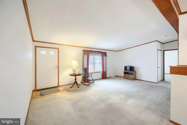 a view of a livingroom with an empty space and a fireplace