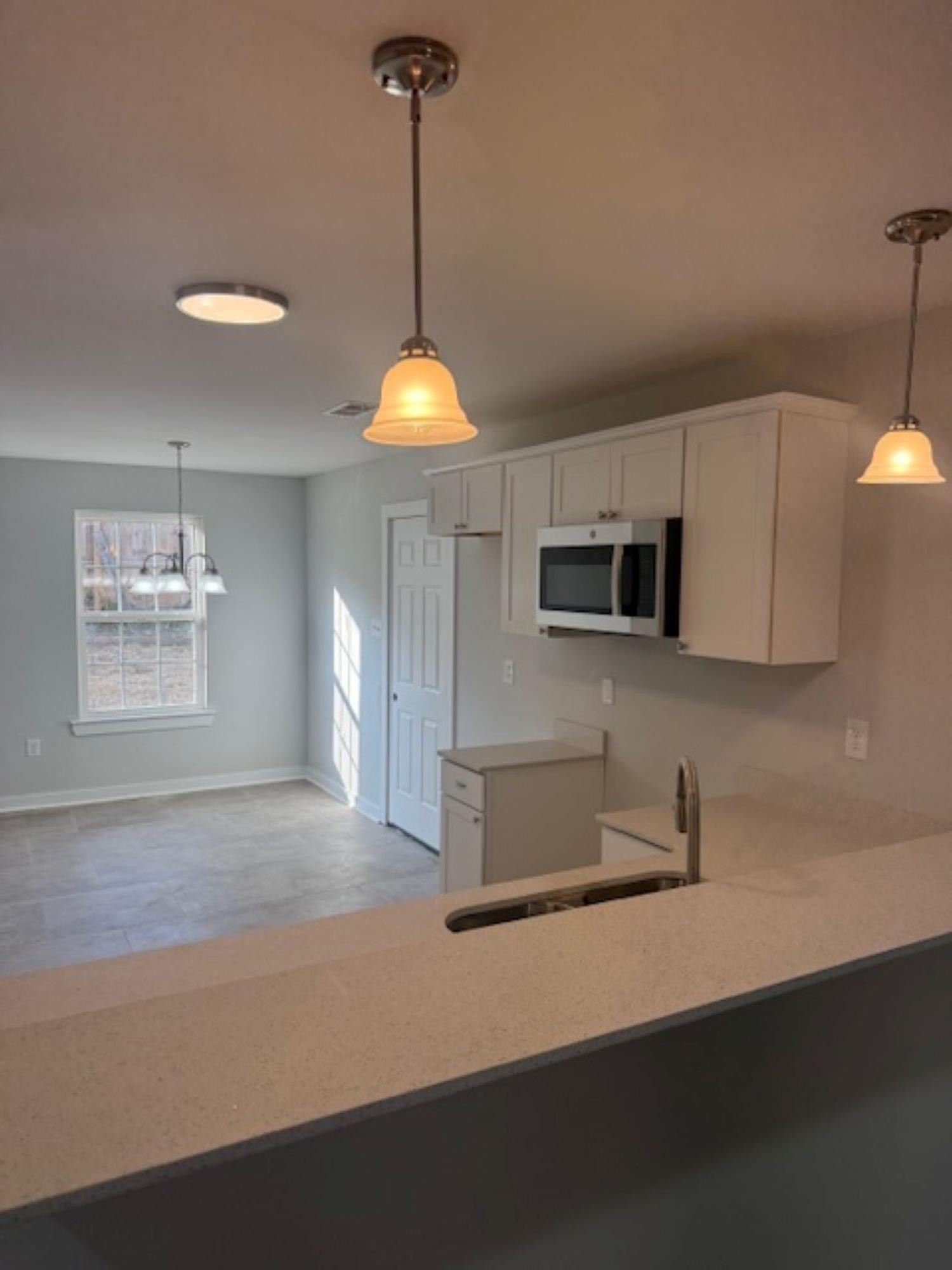 3245 Norton Road Memphis, TN 38109 - Photo 4 of 5 a kitchen with kitchen island a stove a sink and a counter