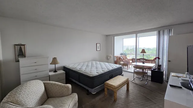 a bathroom with a granite countertop toilet and a sink