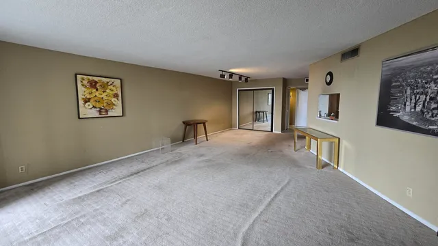 a view of a hallway with paintings on the wall