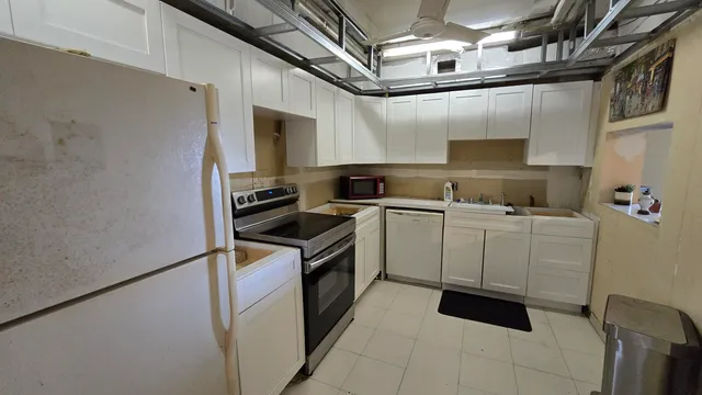 a kitchen with a stove cabinets and a sink