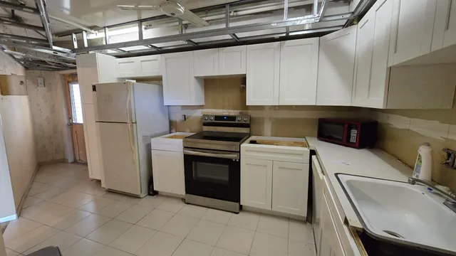 a kitchen with a refrigerator sink and stove