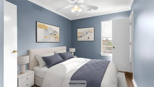 a bedroom with a bed and painting on the wall