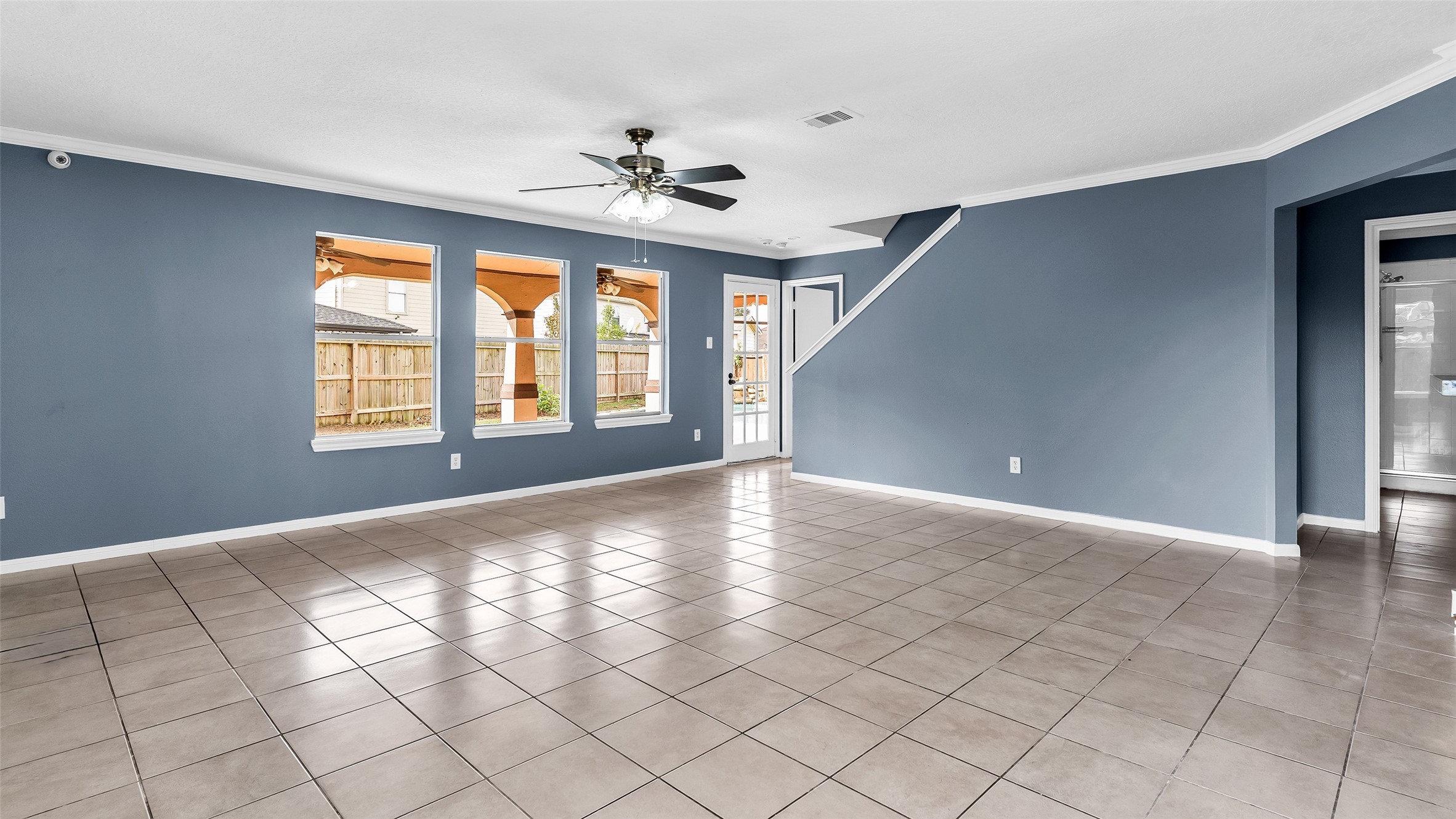 5534 Calm Court Houston, TX 77084 - Photo 4 of 44 a view of an empty room with window and chandelier fan