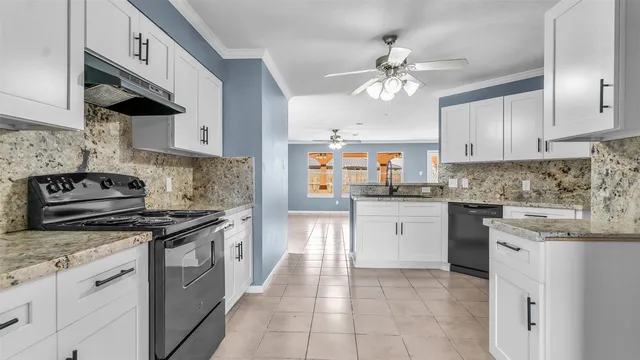a kitchen with granite countertop cabinets and steel stainless steel appliances