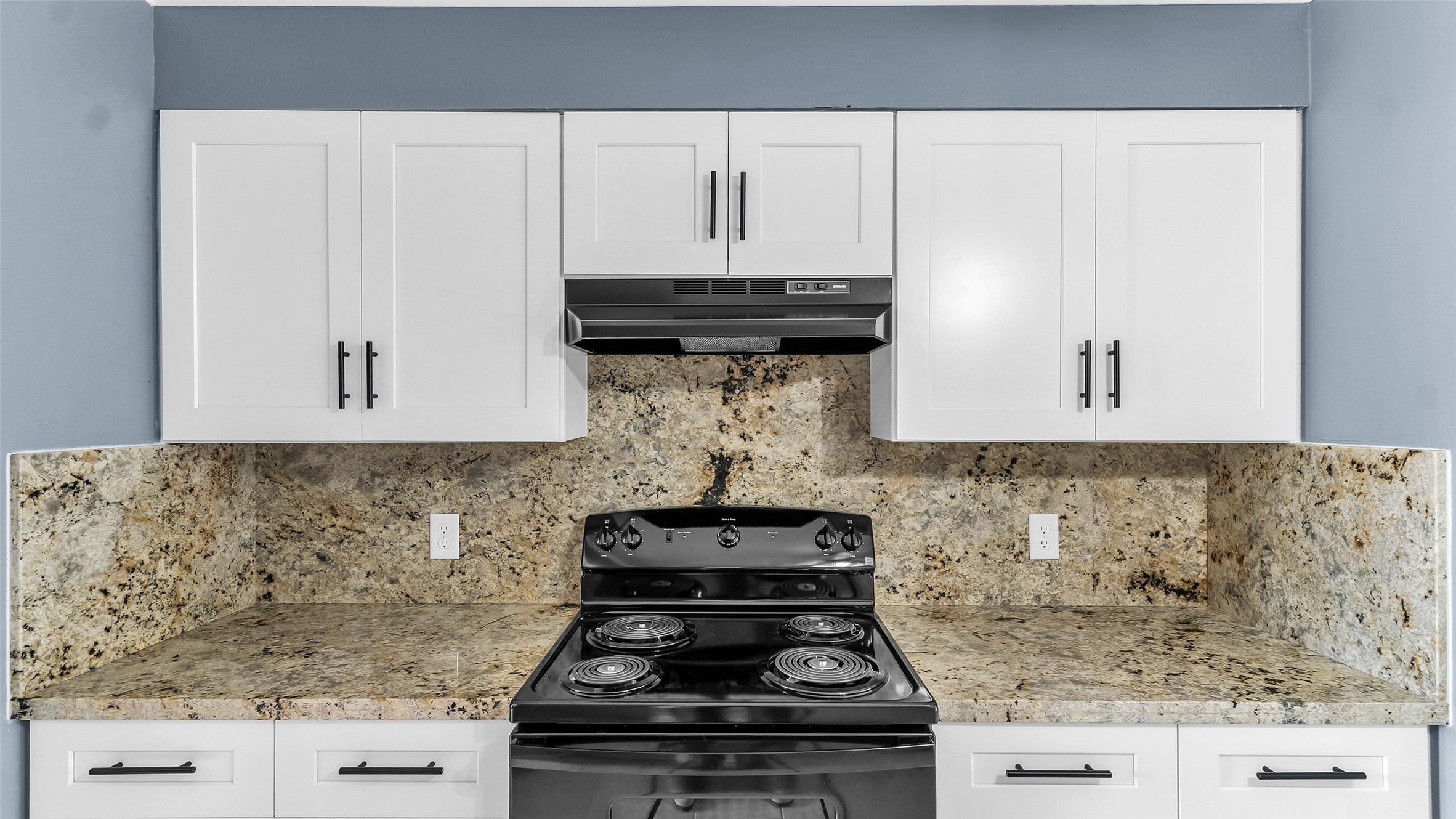 5534 Calm Court Houston, TX 77084 - Photo 9 of 44 a kitchen with a stove and cabinets