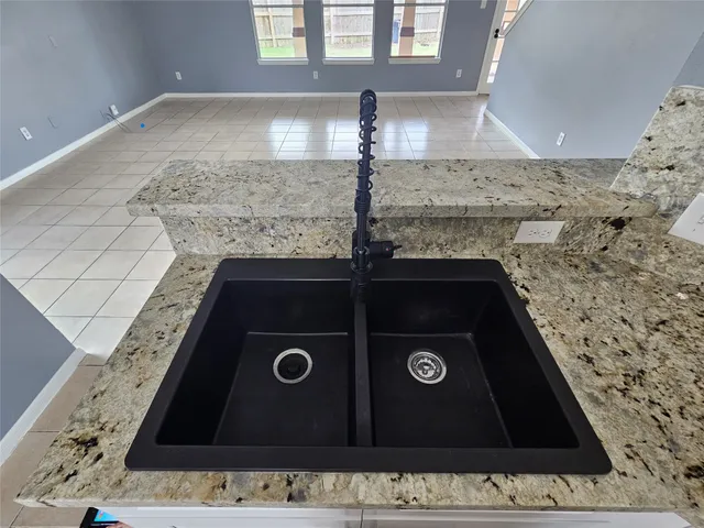 a view of a livingroom with a chandelier and entryway