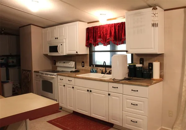 a kitchen with appliances cabinets and a sink