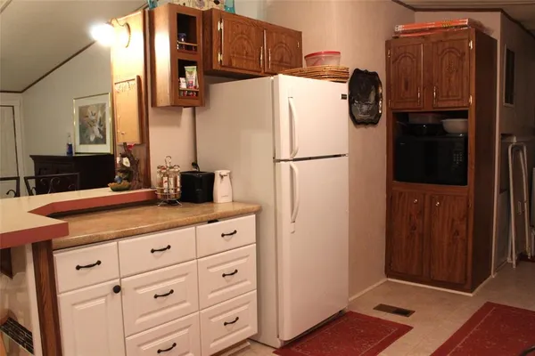 a kitchen with stainless steel appliances a refrigerator and cabinets