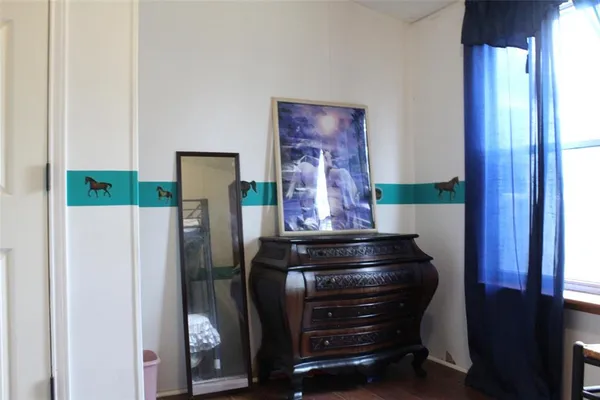 a room with a refrigerator and furniture