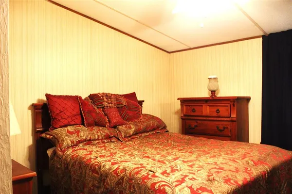 a bed sitting in a bedroom next to a window