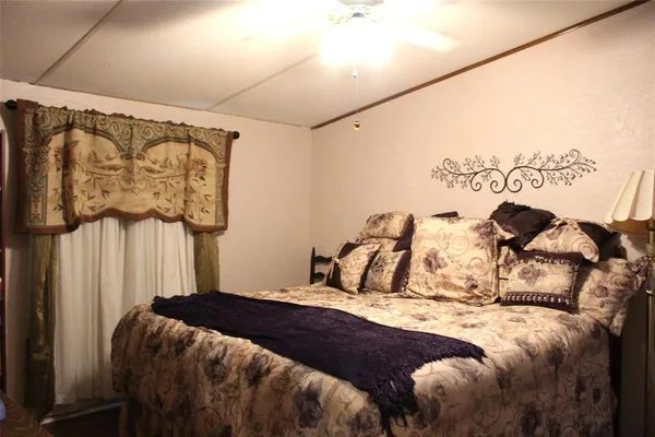 a bedroom with a bed and a painting on the wall