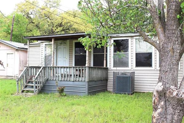 a view of backyard with deck and a garden
