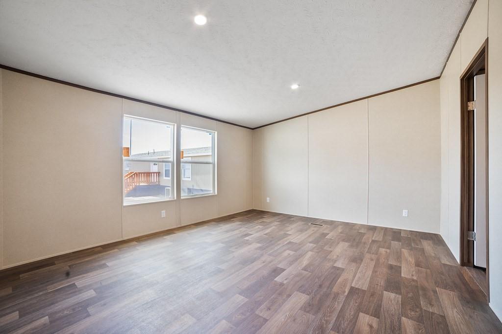 1000 Carnagie Road Poolville, TX 76487 - Photo 22 of 36 a view of an empty room with wooden floor and a window