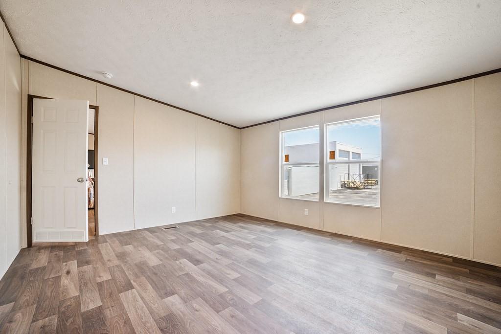 1000 Carnagie Road Poolville, TX 76487 - Photo 23 of 36 a view of empty room with wooden floor and fan