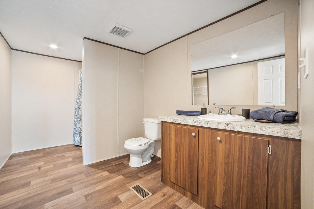 1000 Carnagie Road Poolville, TX 76487 - Photo 24 of 36 a bathroom with a granite countertop sink toilet and shower