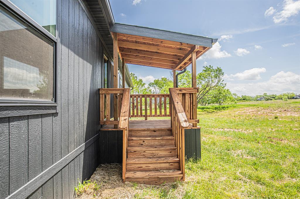 1000 Carnagie Road Poolville, TX 76487 - Photo 33 of 36 a view of a porch with wooden floor and outdoor space