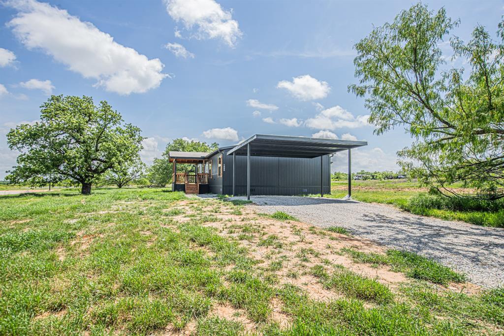 1000 Carnagie Road Poolville, TX 76487 - Photo 34 of 36 a house view with a garden space