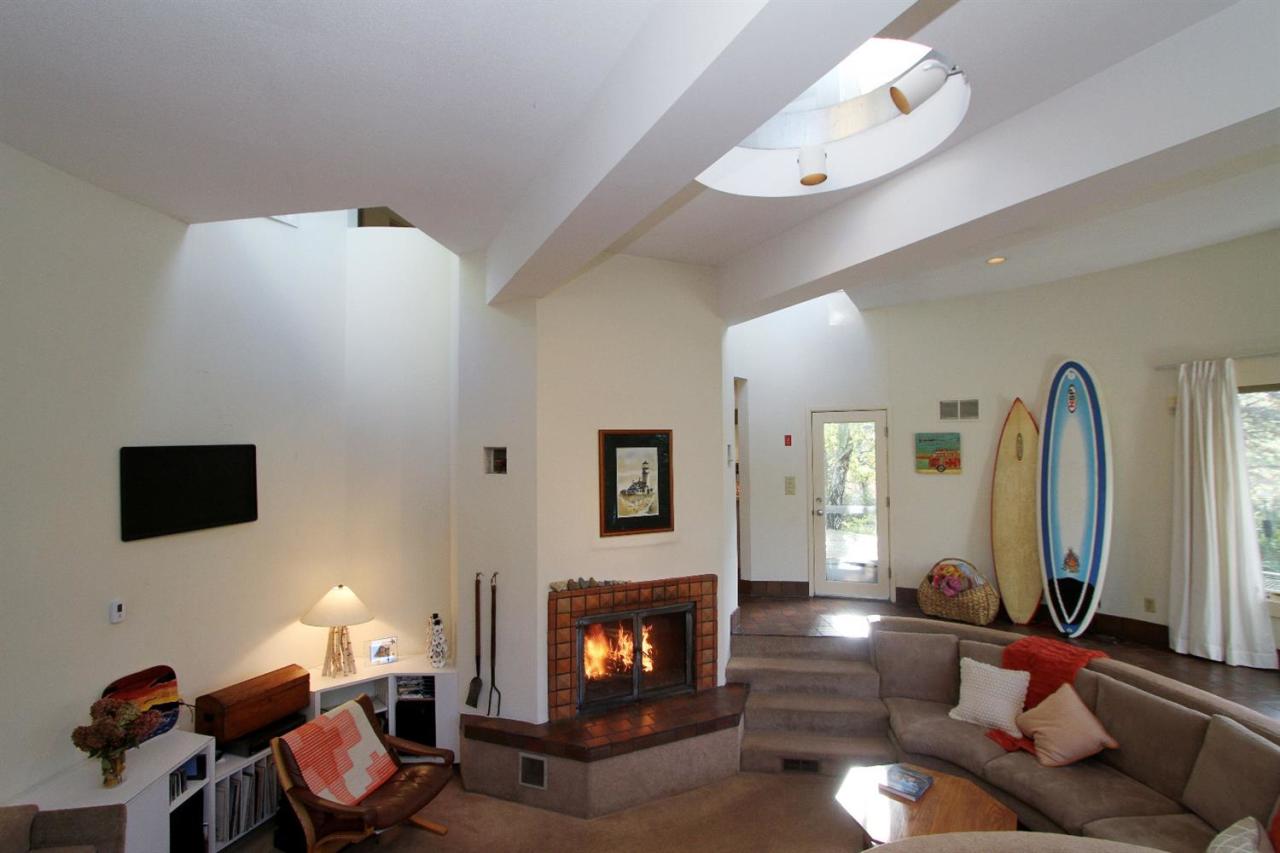 5 First Discovery Road Truro, MA 02666 - Photo 3 of 34 a living room with furniture a flat screen tv and a fireplace