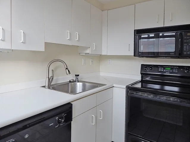 a kitchen with sink a microwave and stove