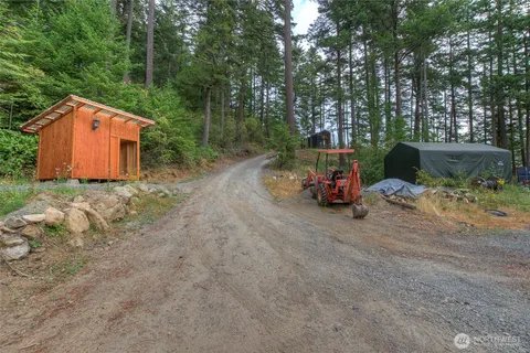 a backyard of a house with barbeque oven table and chairs