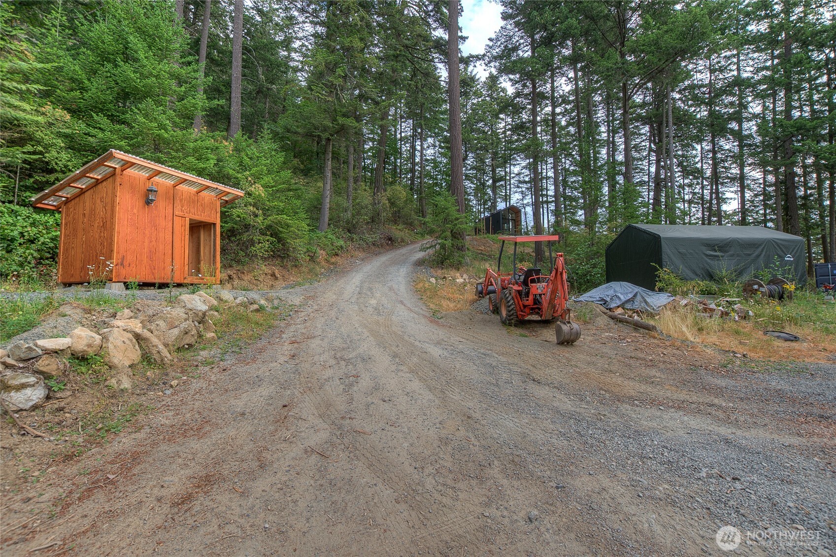 300 Pleasure Horse Road Orcas Island, WA 98245 - Photo 19 of 31 a backyard of a house with barbeque oven table and chairs