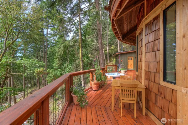 a view of balcony with chairs and wooden fence