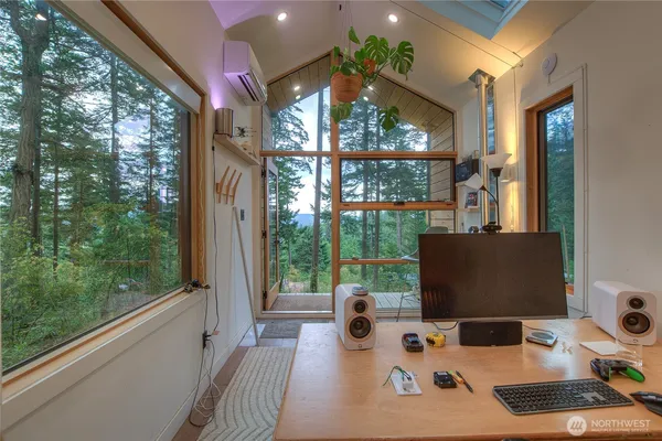 a work room with furniture and a large window