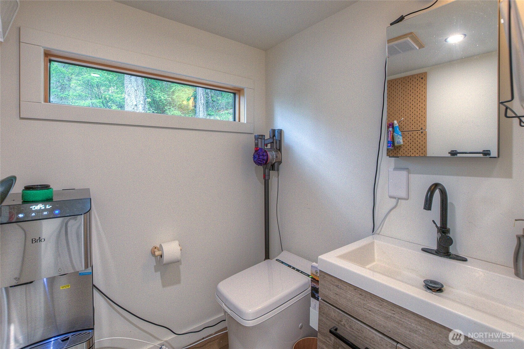 300 Pleasure Horse Road Orcas Island, WA 98245 - Photo 25 of 31 a bathroom with a sink a toilet and a mirror