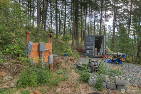 a backyard of a house with table and chairs large trees