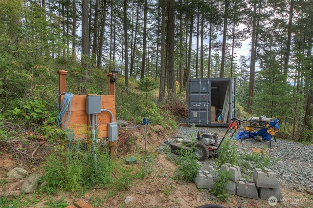 a backyard of a house with table and chairs large trees