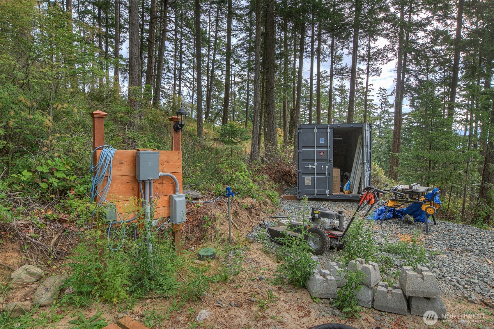 300 Pleasure Horse Road Orcas Island, WA 98245 - Photo 26 of 31 a backyard of a house with table and chairs large trees