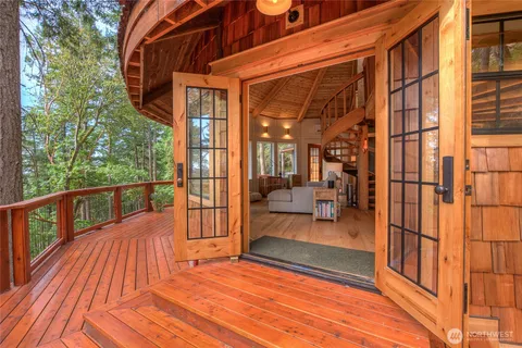 a view of a balcony with chairs and wooden floor