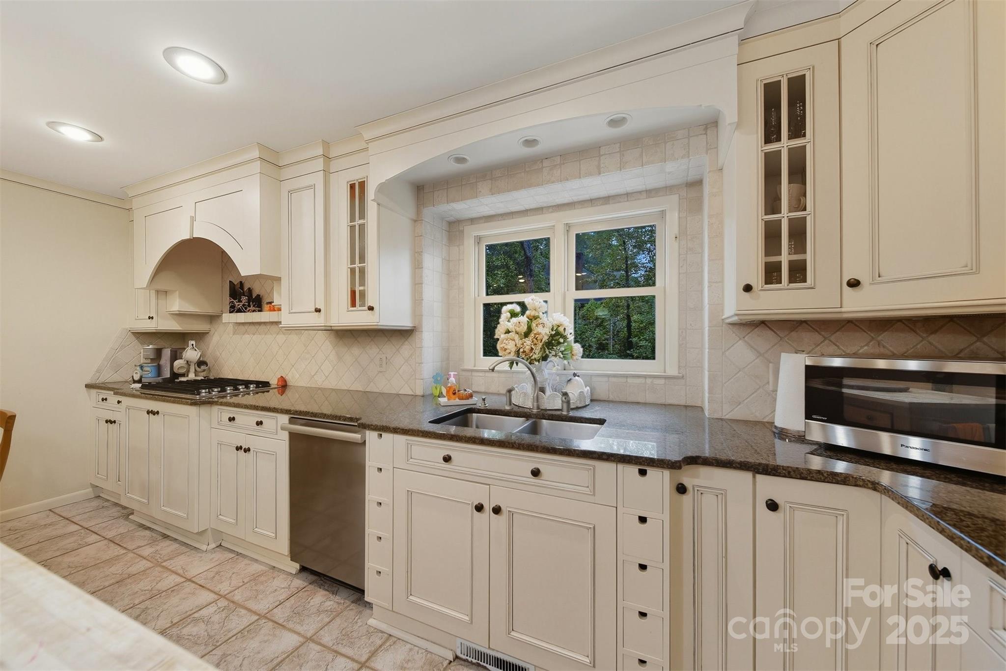 507 6th Avenue Northeast Conover, NC 28613 - Photo 11 of 48 a kitchen with granite countertop white cabinets white appliances and a sink