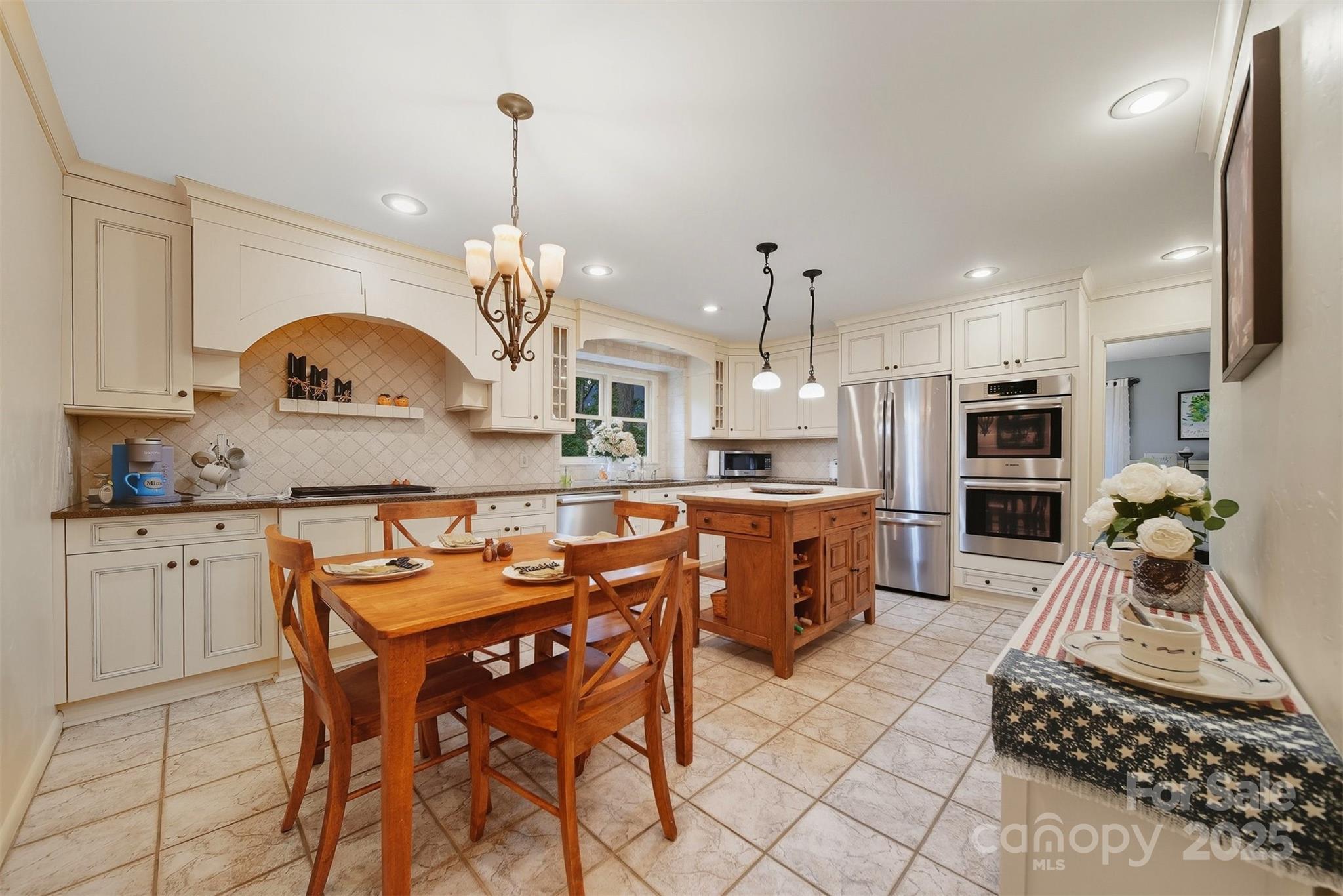 507 6th Avenue Northeast Conover, NC 28613 - Photo 9 of 48 a kitchen with stainless steel appliances granite countertop a stove top oven a sink dishwasher a dining table and chairs with wooden floor