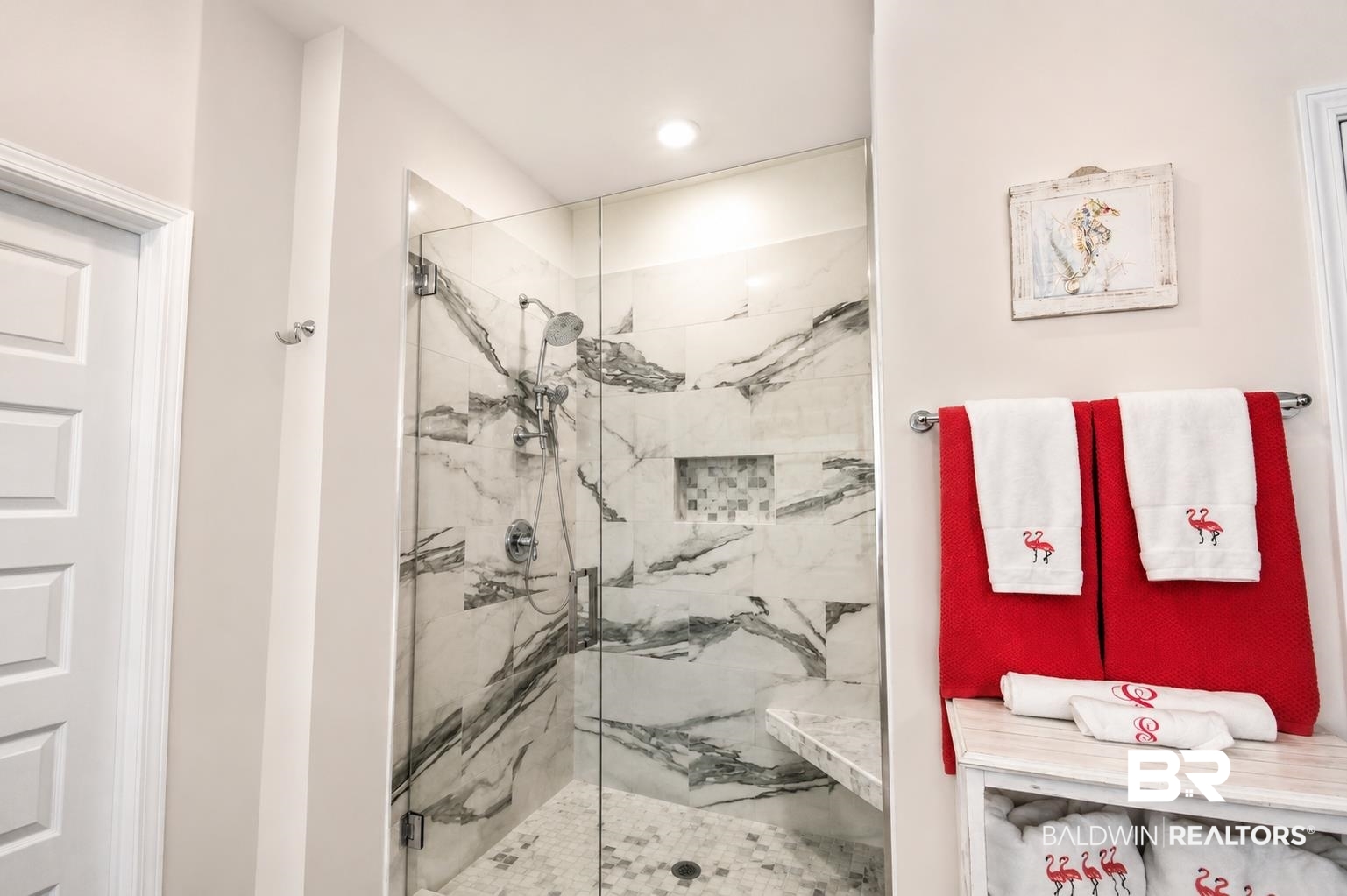 1885 Carly Street Foley, AL 36535 - Photo 19 of 40 Shower enclosure featuring glass panels, marble-patterned wall tile, a built-in bench, and a mosaic-tiled niche