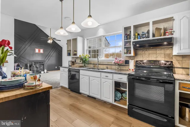 a kitchen with a stove and a white cabinets