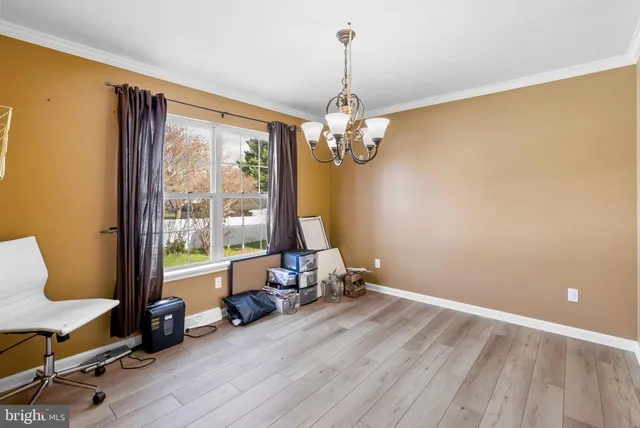 a view of a room with furniture wooden floor and windows