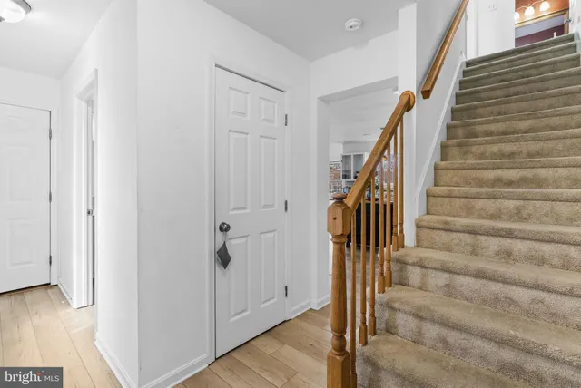 a view of entryway with wooden floor and stairs