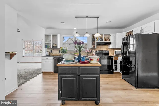 a kitchen with stainless steel appliances granite countertop a stove and refrigerator