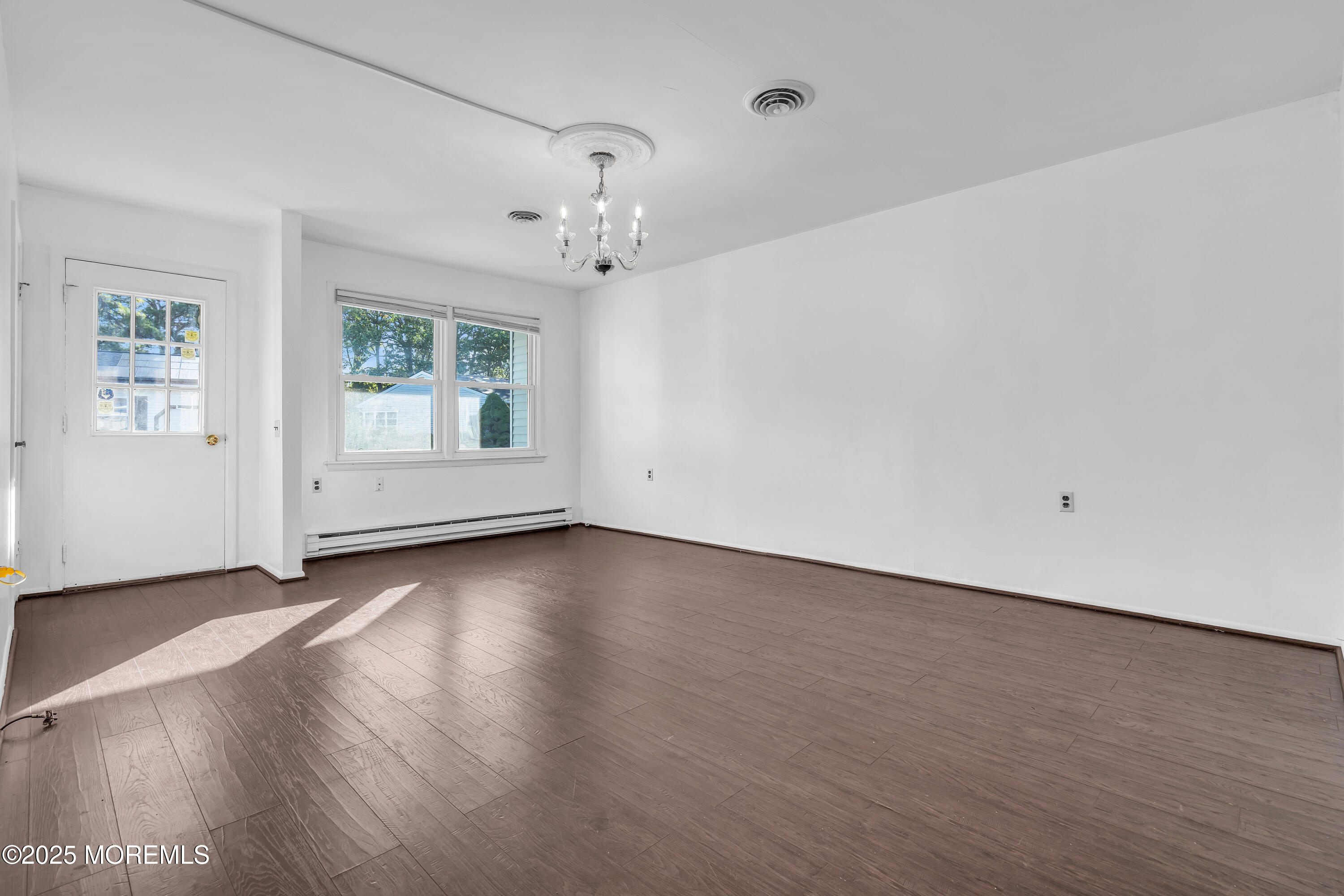 11 Hartford Road, Unit 70 Whiting, NJ 08759 - Photo 11 of 32 an empty room with wooden floor and window