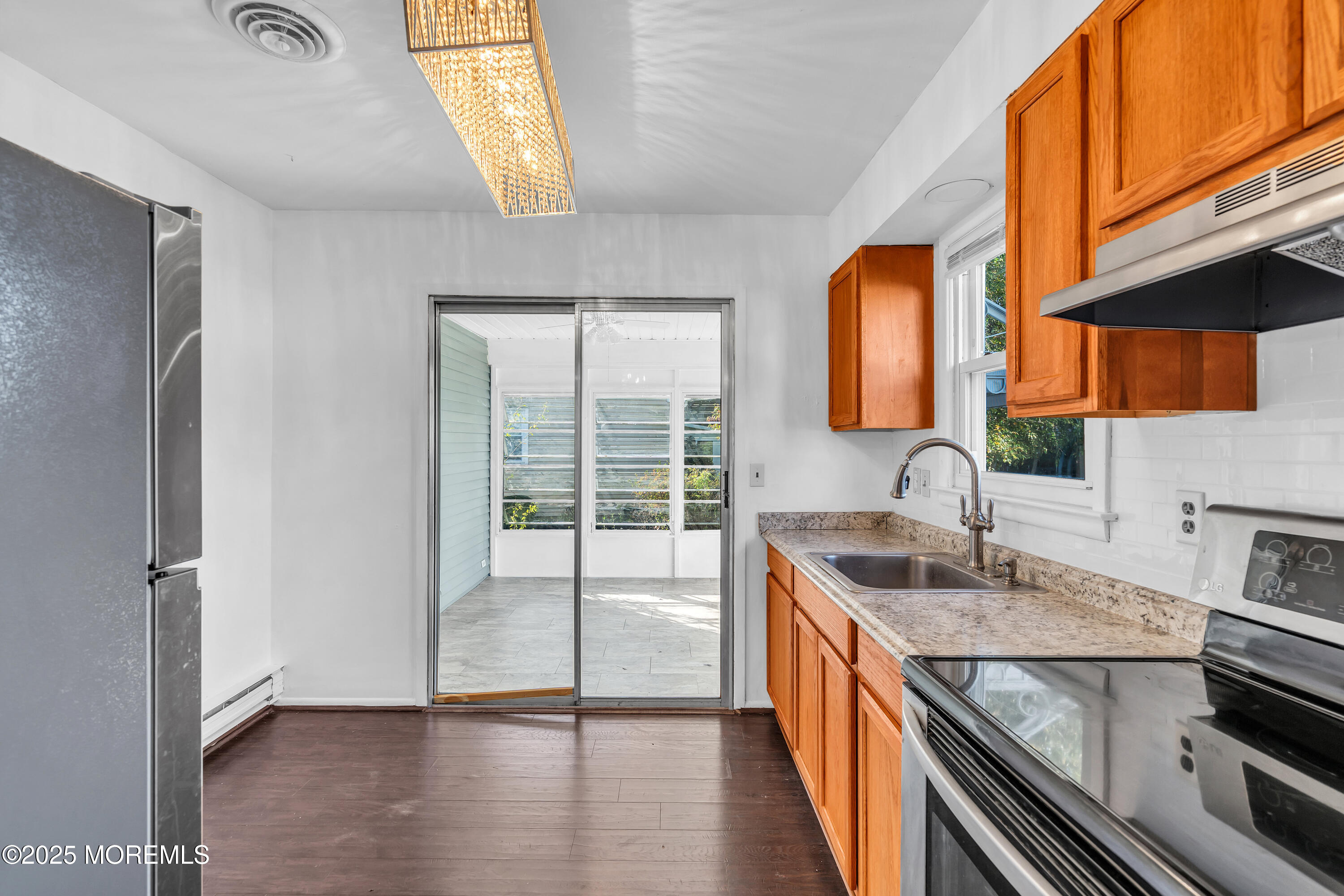 11 Hartford Road, Unit 70 Whiting, NJ 08759 - Photo 18 of 32 a kitchen that has a sink and a stove