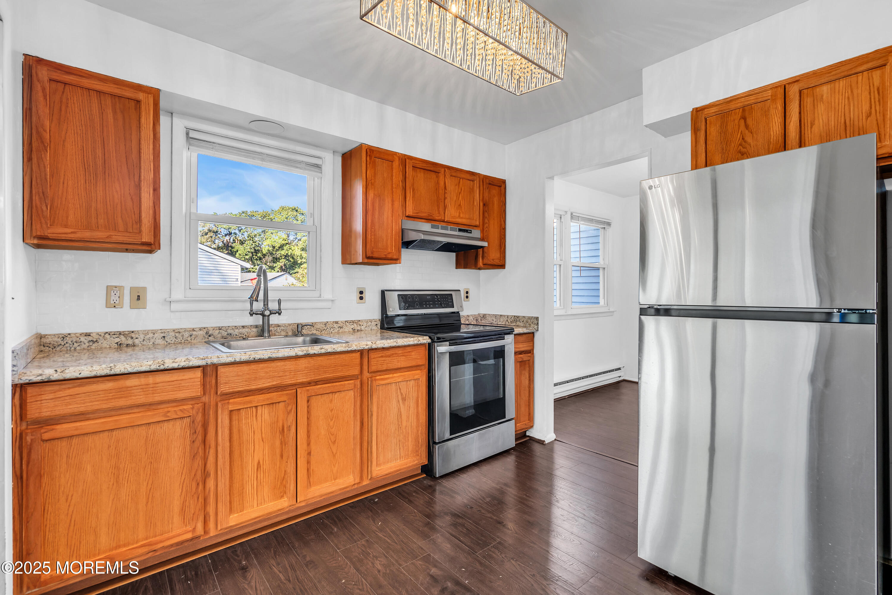 11 Hartford Road, Unit 70 Whiting, NJ 08759 - Photo 20 of 32 a kitchen with stainless steel appliances granite countertop a refrigerator sink and stove