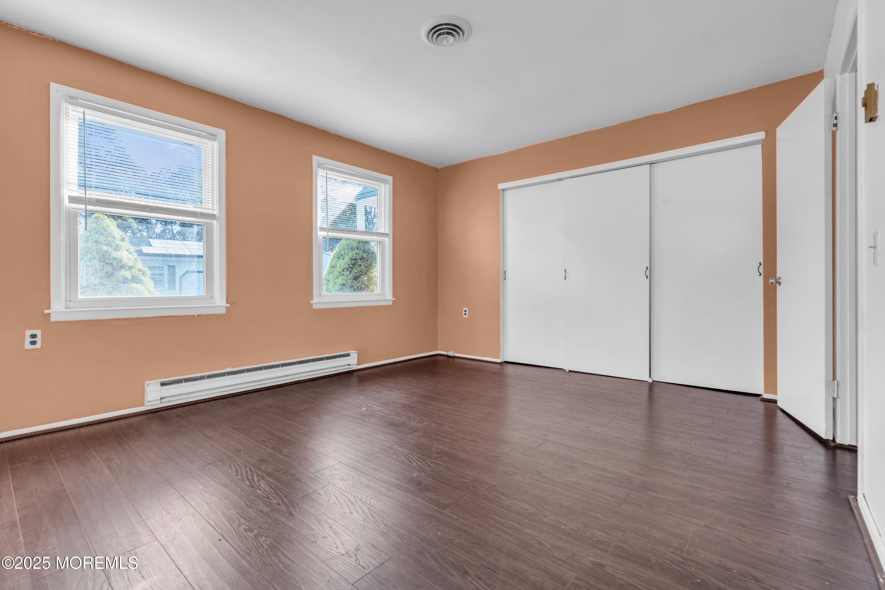 11 Hartford Road, Unit 70 Whiting, NJ 08759 - Photo 23 of 32 an empty room with wooden floor and windows