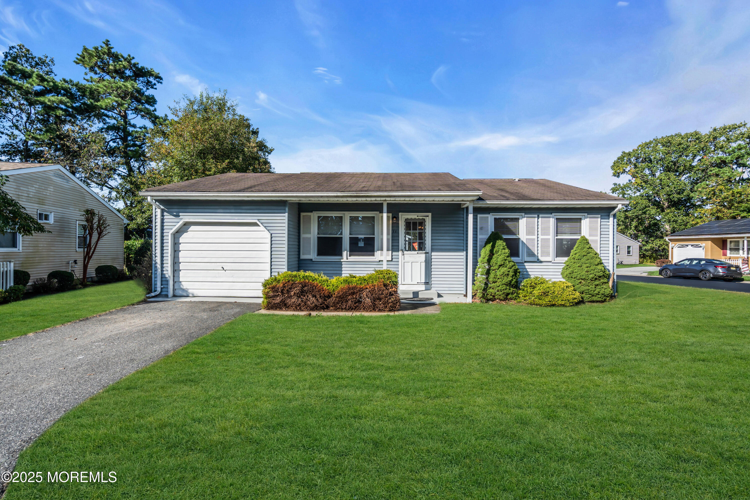 11 Hartford Road, Unit 70 Whiting, NJ 08759 - Photo 30 of 32 a view of a house with a yard and plants