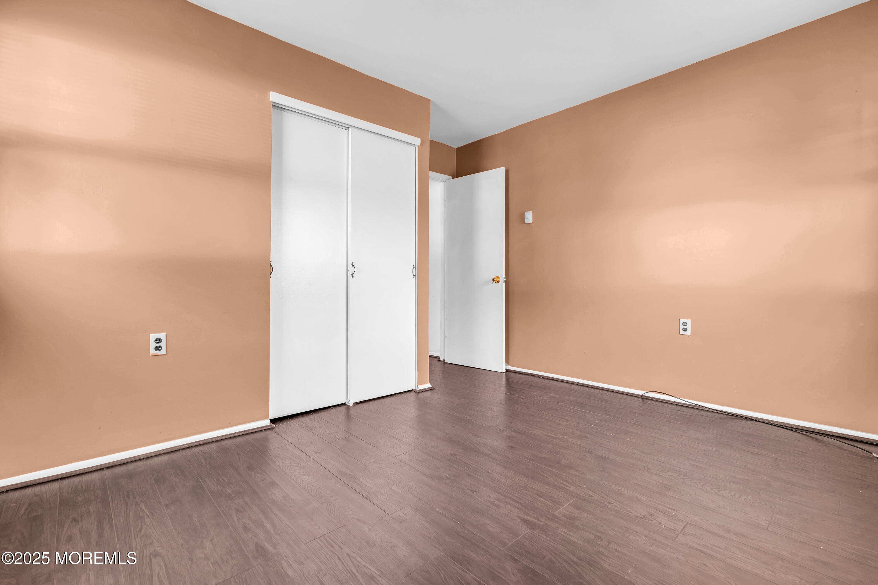 11 Hartford Road, Unit 70 Whiting, NJ 08759 - Photo 3 of 32 a view of an empty room with wooden floor and a window