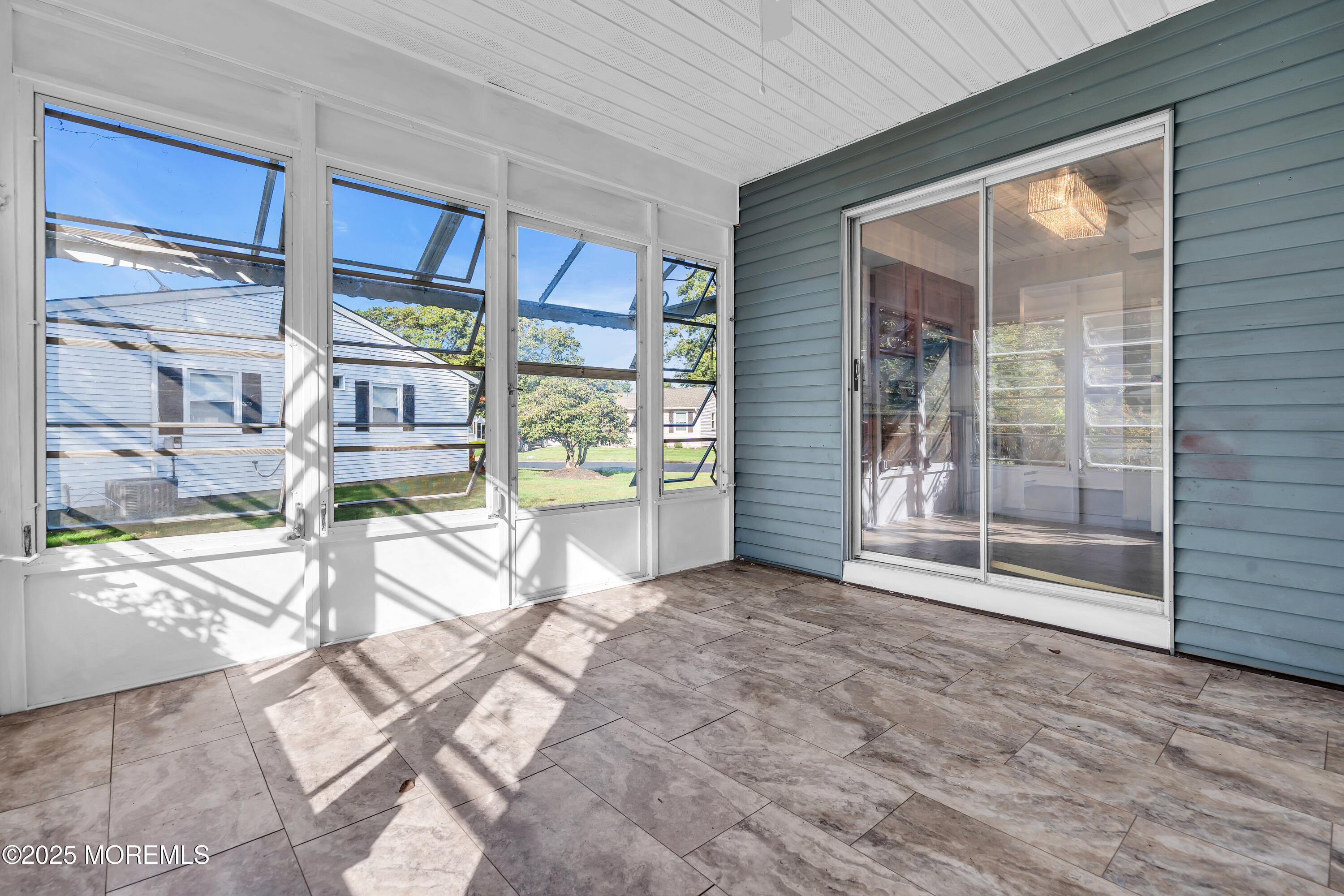 11 Hartford Road, Unit 70 Whiting, NJ 08759 - Photo 4 of 32 a view of empty room with floor to ceiling window and outdoor kitchen