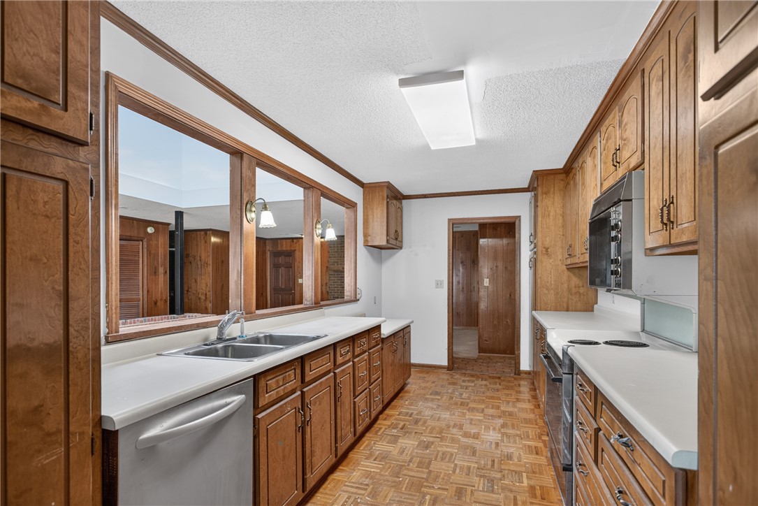 1412 Simpson Road Pendleton, SC 29670 - Photo 8 of 48 A well-lit kitchen with ample wooden cabinetry and a classic checkerboard floor pattern.
